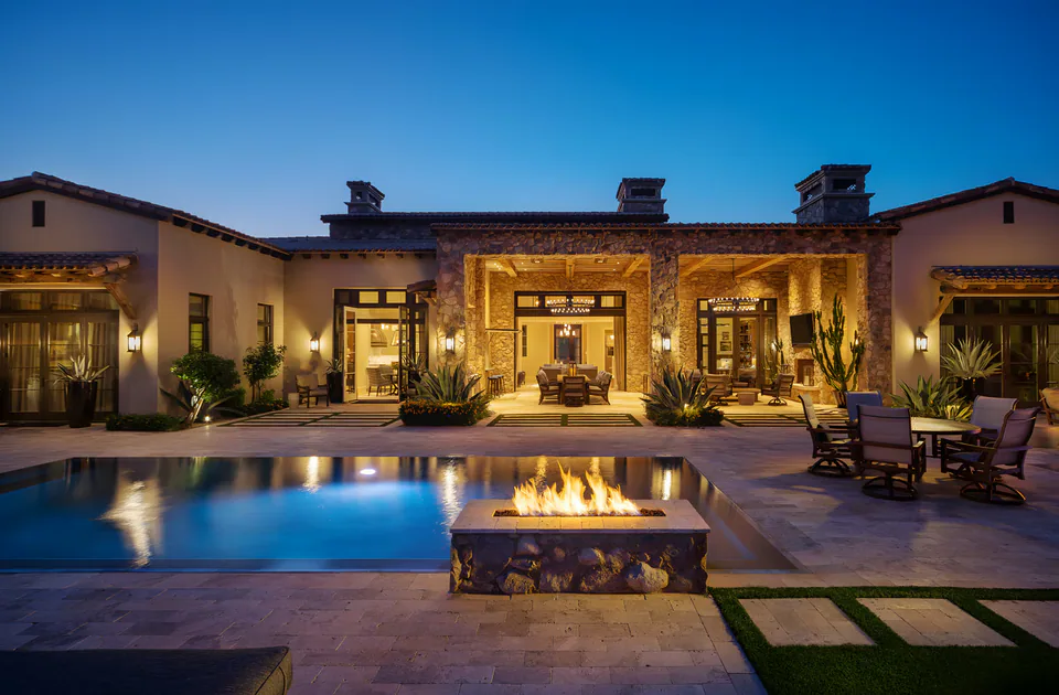 Pool terrace at dusk at Desert Classic, Scottsdale, Arizona, interior design by Paul Lauren Designs