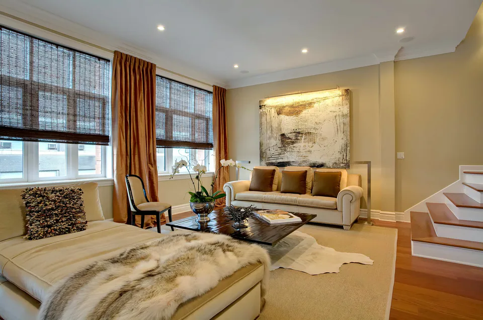 Living room with fur throw and warm drapery, interior design by Paul Lauren Designs